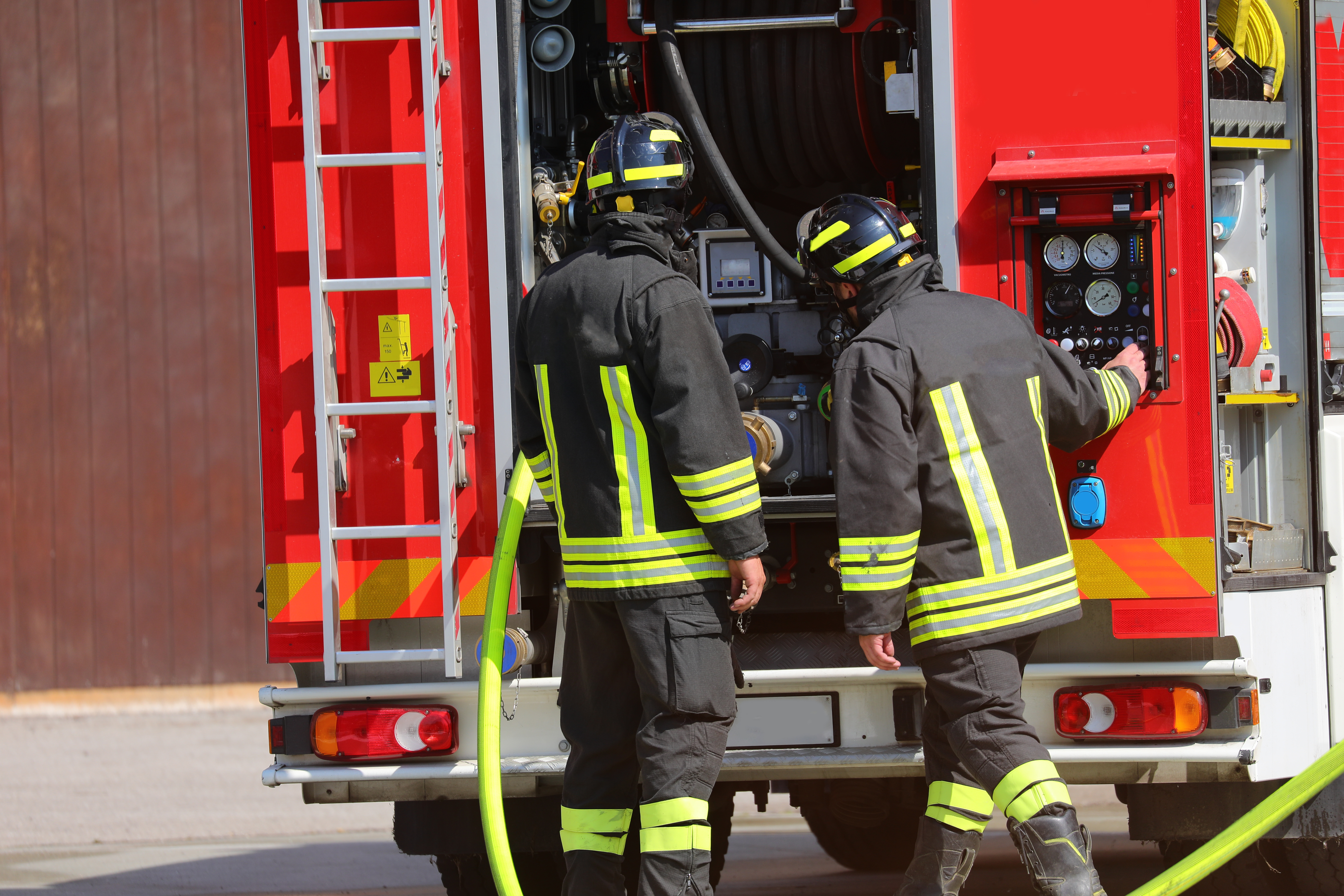 Firefighters using pump panel